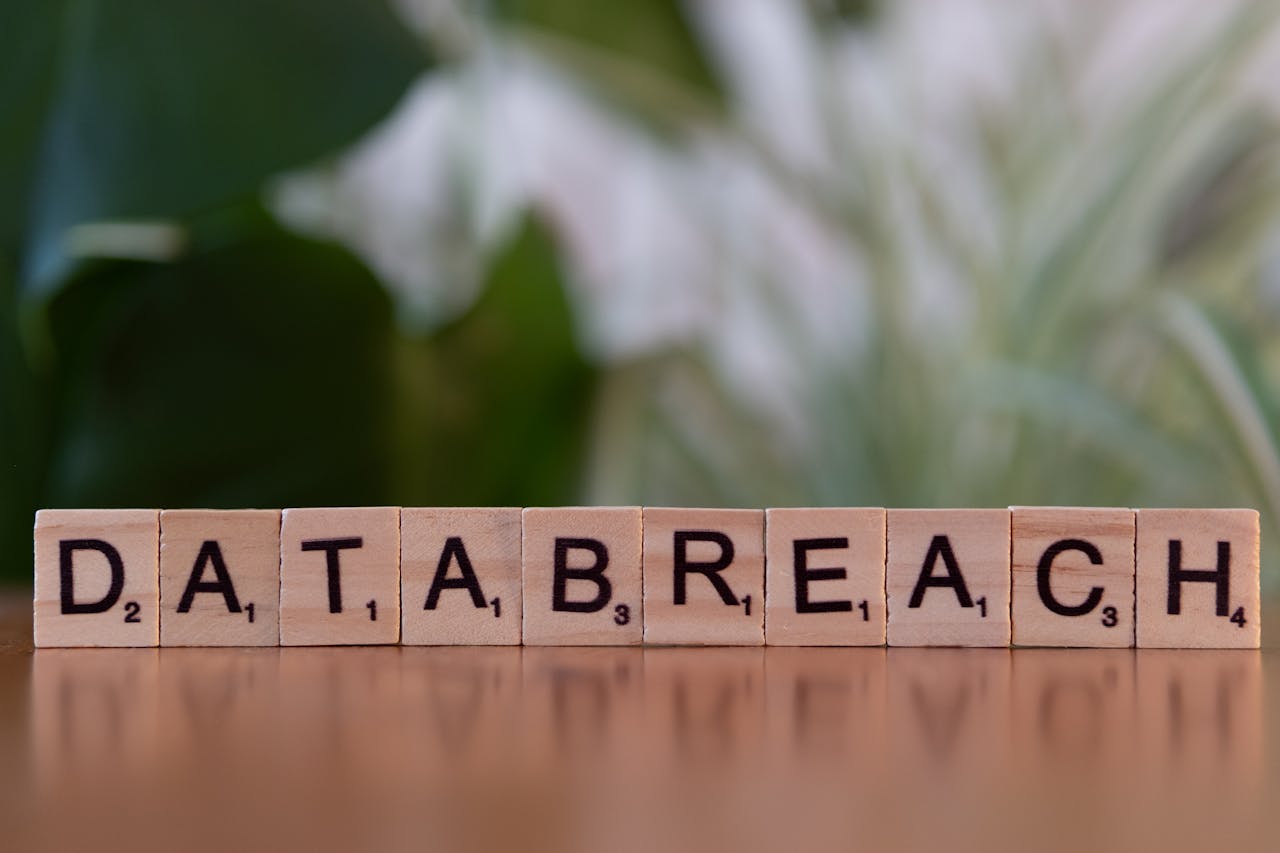Close-up of Scrabble tiles spelling data breach on a blurred background